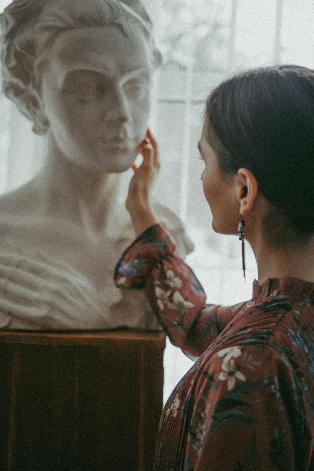 Portrait of a woman historian with glasses in an archive